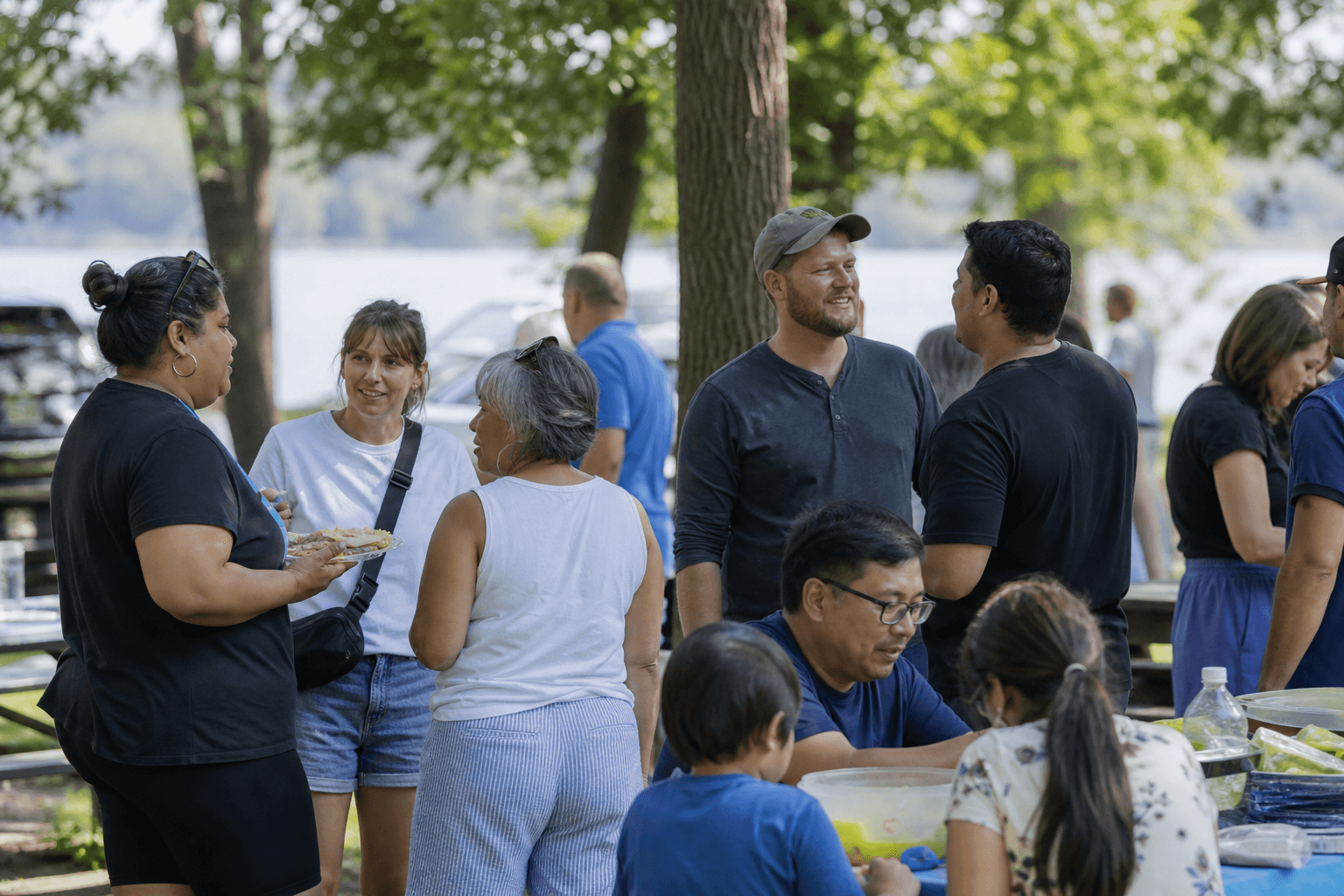 Neighbors gathering outdoors in a Minnesota community park